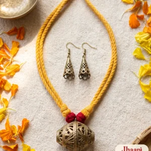 Dhol dokra necklace and cone jhumkas on handloom with marigolds